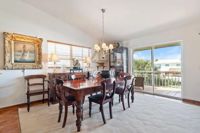 a kitchen with a large window and chairs