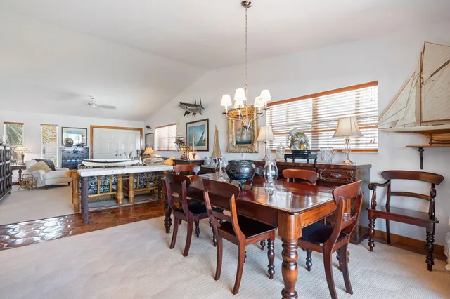 a living room with furniture and large windows