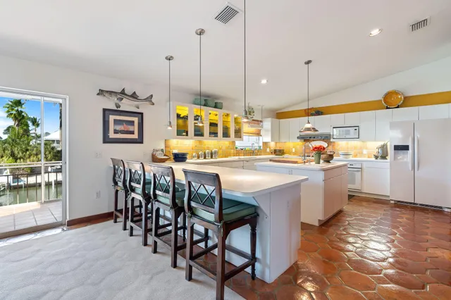 a bed room with a bed a couch and a flat screen tv