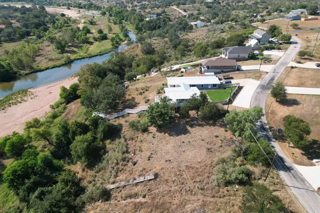 an aerial view of a house with a yard