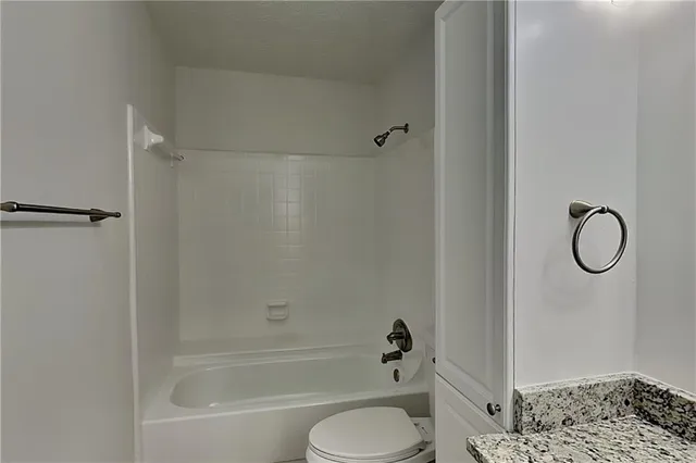 a bathroom with a bathtub toilet and shower