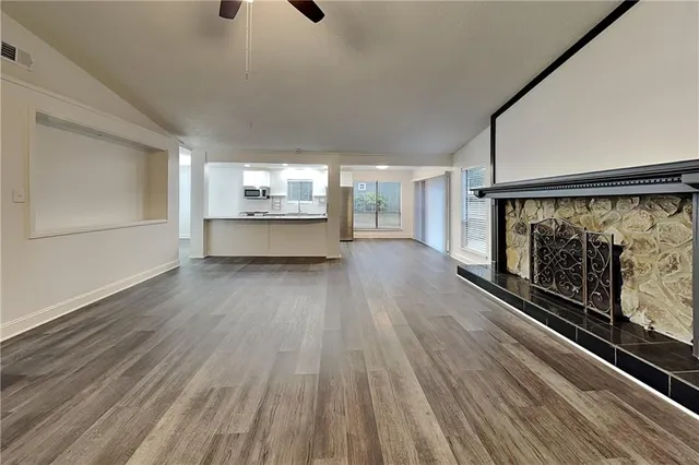 a view of a room with wooden floor