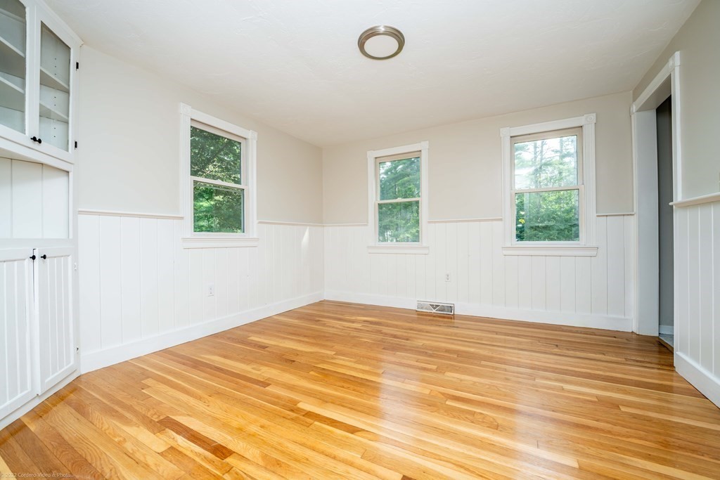 1 Canterberry Path Carver, MA 02330 - Photo 14 of 40 a view of an empty room with wooden floor and a window