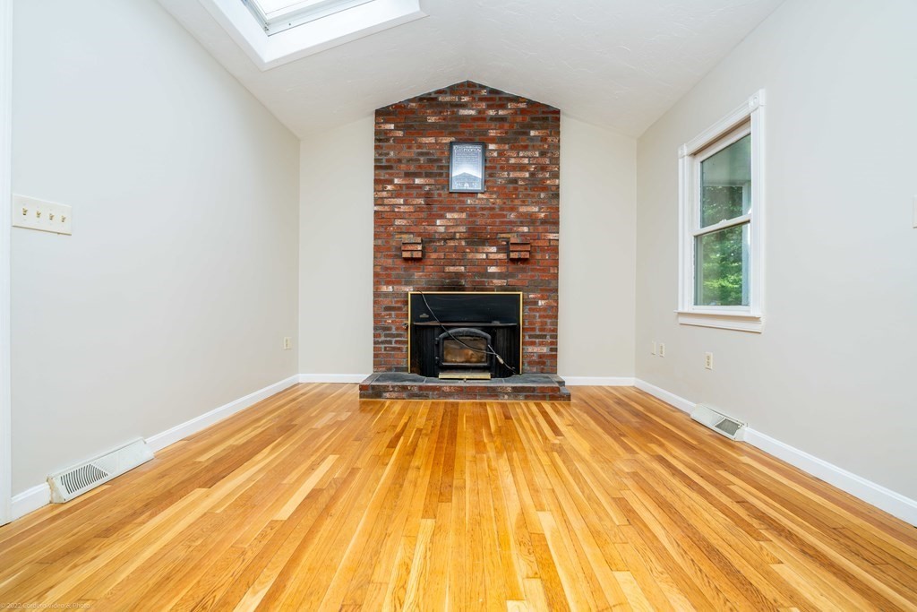 1 Canterberry Path Carver, MA 02330 - Photo 16 of 40 a view of empty room with wooden floor and fireplace