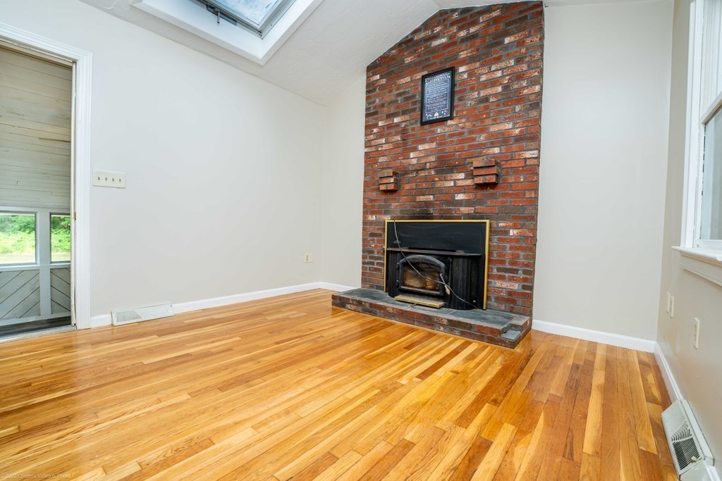 1 Canterberry Path Carver, MA 02330 - Photo 17 of 40 a view of empty room with wooden floor and fireplace