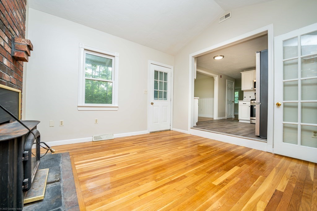 1 Canterberry Path Carver, MA 02330 - Photo 19 of 40 a view of an empty room with wooden floor and a window