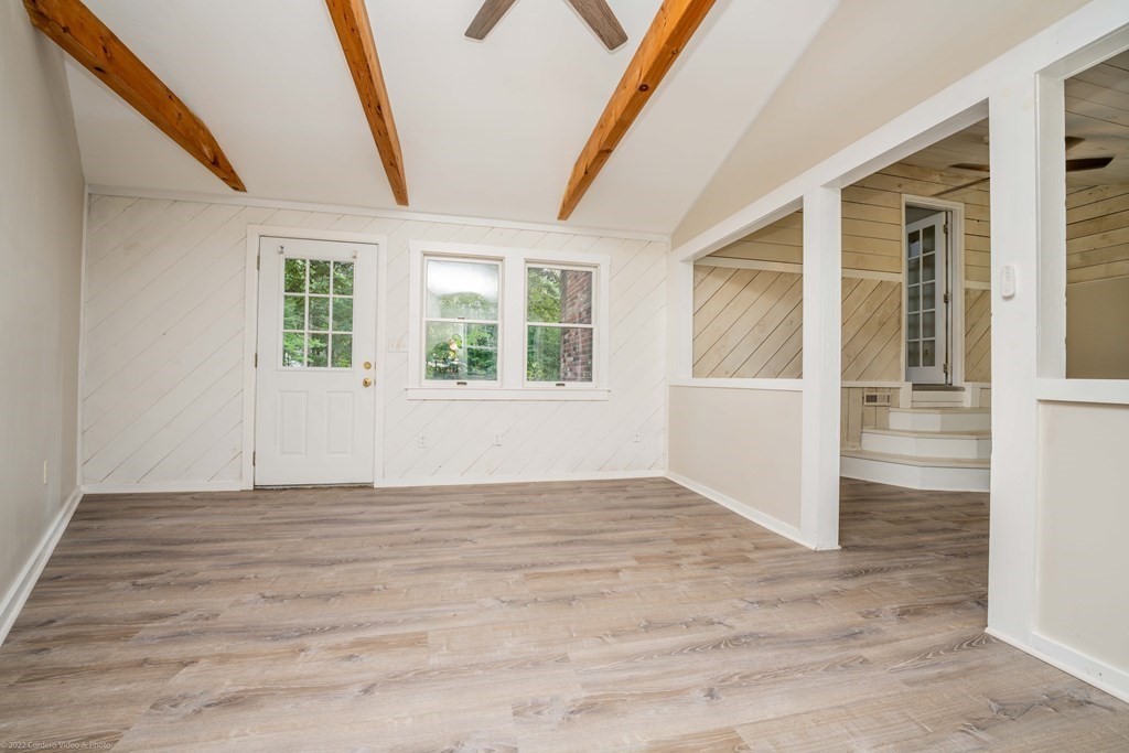 1 Canterberry Path Carver, MA 02330 - Photo 22 of 40 a view of an empty room with wooden floor and a window