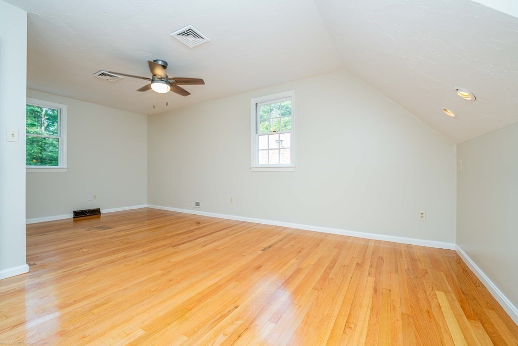 1 Canterberry Path Carver, MA 02330 - Photo 24 of 40 a view of an empty room with wooden floor and a window