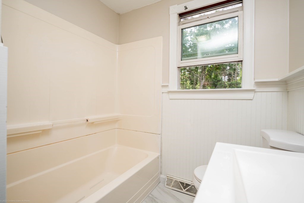 1 Canterberry Path Carver, MA 02330 - Photo 28 of 40 a bath tub sitting next to a white toilet and a window