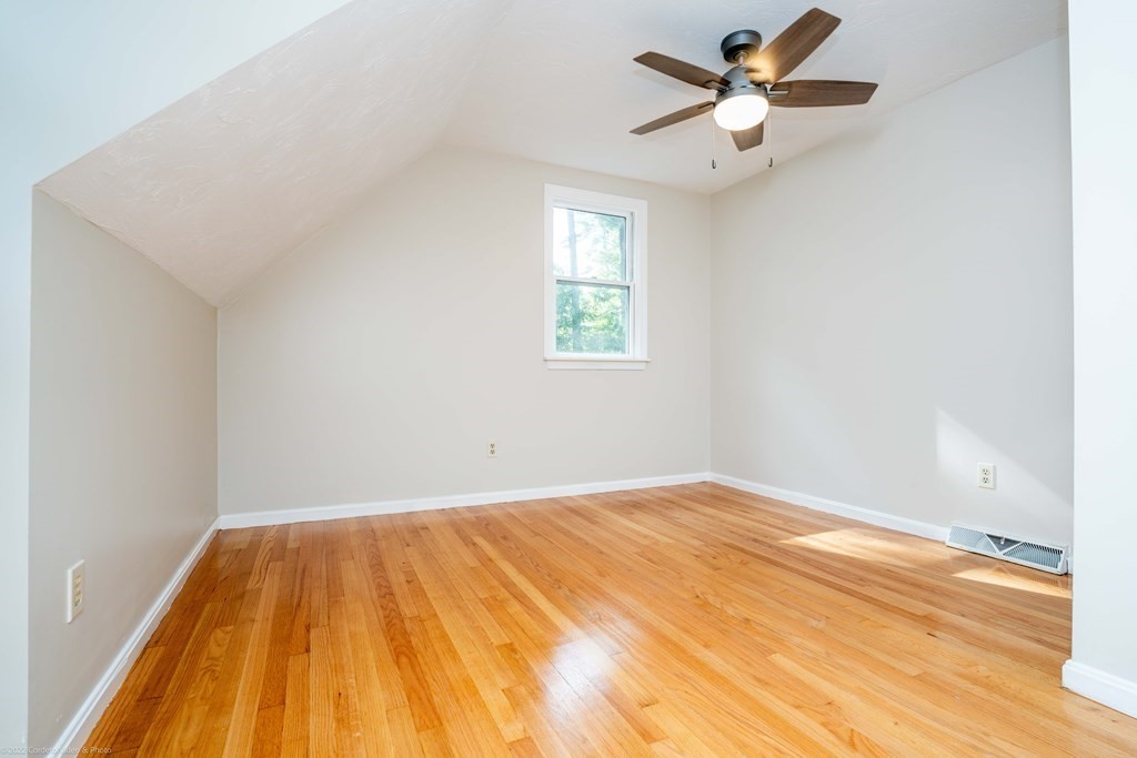 1 Canterberry Path Carver, MA 02330 - Photo 29 of 40 a view of a big room with wooden floor and a chandelier fan