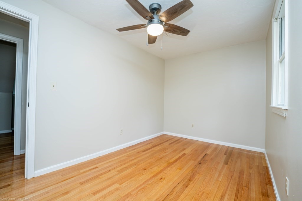 1 Canterberry Path Carver, MA 02330 - Photo 31 of 40 an empty room with a fan and a window