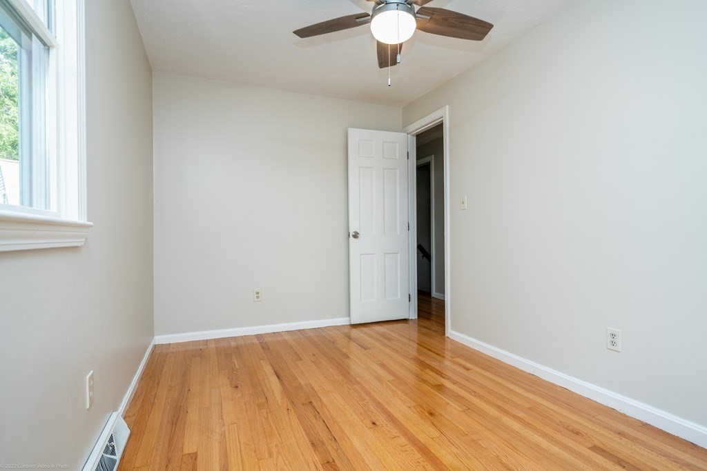 1 Canterberry Path Carver, MA 02330 - Photo 32 of 40 an empty room with wooden floor fan and windows