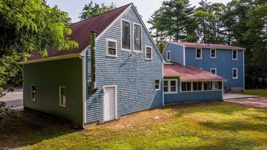 1 Canterberry Path Carver, MA 02330 - Photo 37 of 40 a front view of a house with a yard and garage