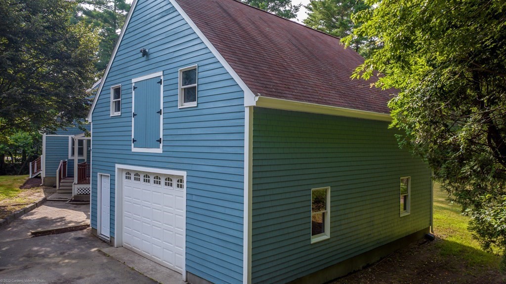 1 Canterberry Path Carver, MA 02330 - Photo 4 of 40 a view of a small house with a yard and wooden fence