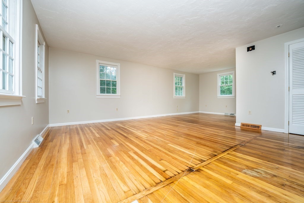 1 Canterberry Path Carver, MA 02330 - Photo 9 of 40 a view of empty room with wooden floor and fan