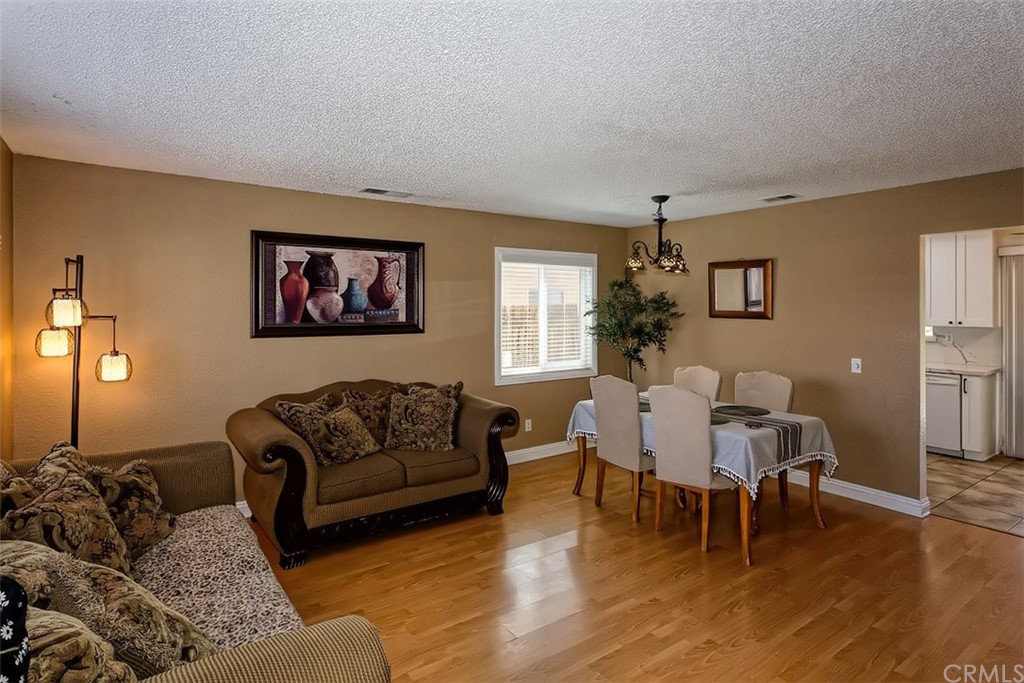 10829 Pepper Street Adelanto, CA 92301 - Photo 12 of 48 a living room with furniture window and wooden floor