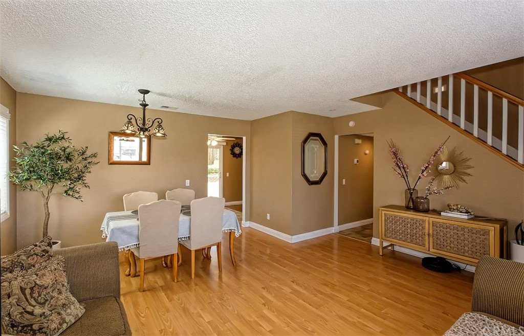 10829 Pepper Street Adelanto, CA 92301 - Photo 13 of 48 a dining room with furniture potted plants and wooden floor