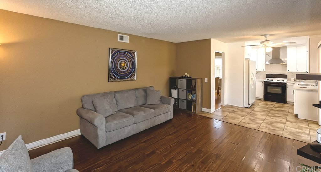 10829 Pepper Street Adelanto, CA 92301 - Photo 19 of 48 a living room with furniture and a kitchen