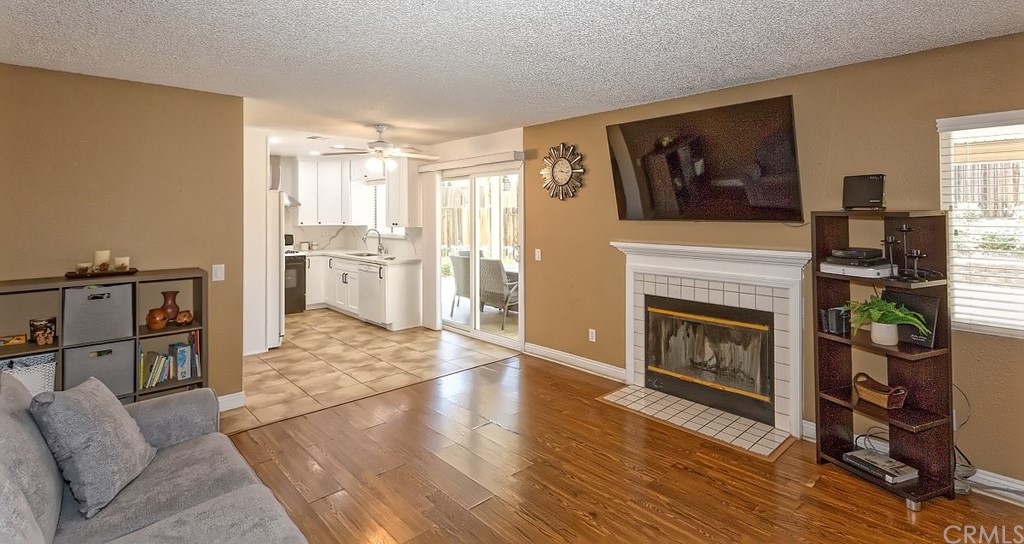 10829 Pepper Street Adelanto, CA 92301 - Photo 20 of 48 a living room with furniture a flat screen tv and a fireplace