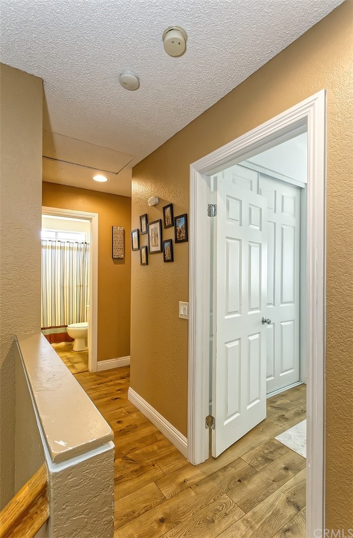 10829 Pepper Street Adelanto, CA 92301 - Photo 27 of 48 a view of a livingroom with wooden floor and a bathroom