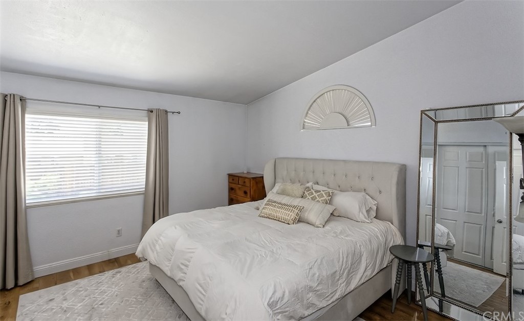 10829 Pepper Street Adelanto, CA 92301 - Photo 28 of 48 a bedroom with a bed and a window