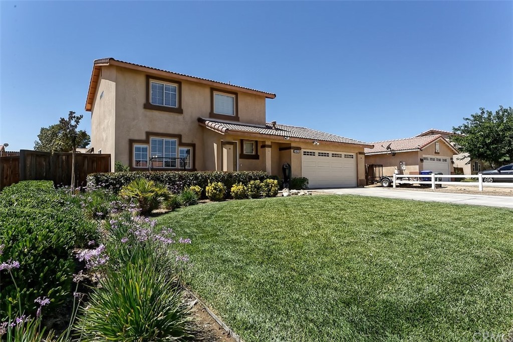 10829 Pepper Street Adelanto, CA 92301 - Photo 3 of 48 a front view of a house with a yard