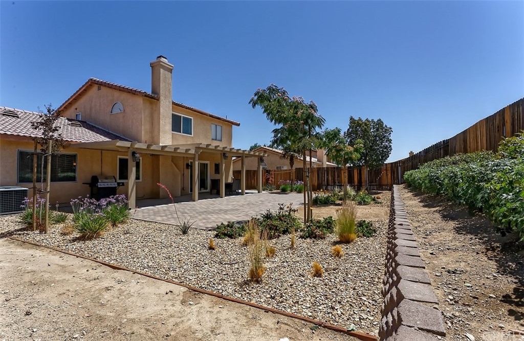 10829 Pepper Street Adelanto, CA 92301 - Photo 39 of 48 a view of a house with backyard and sitting area