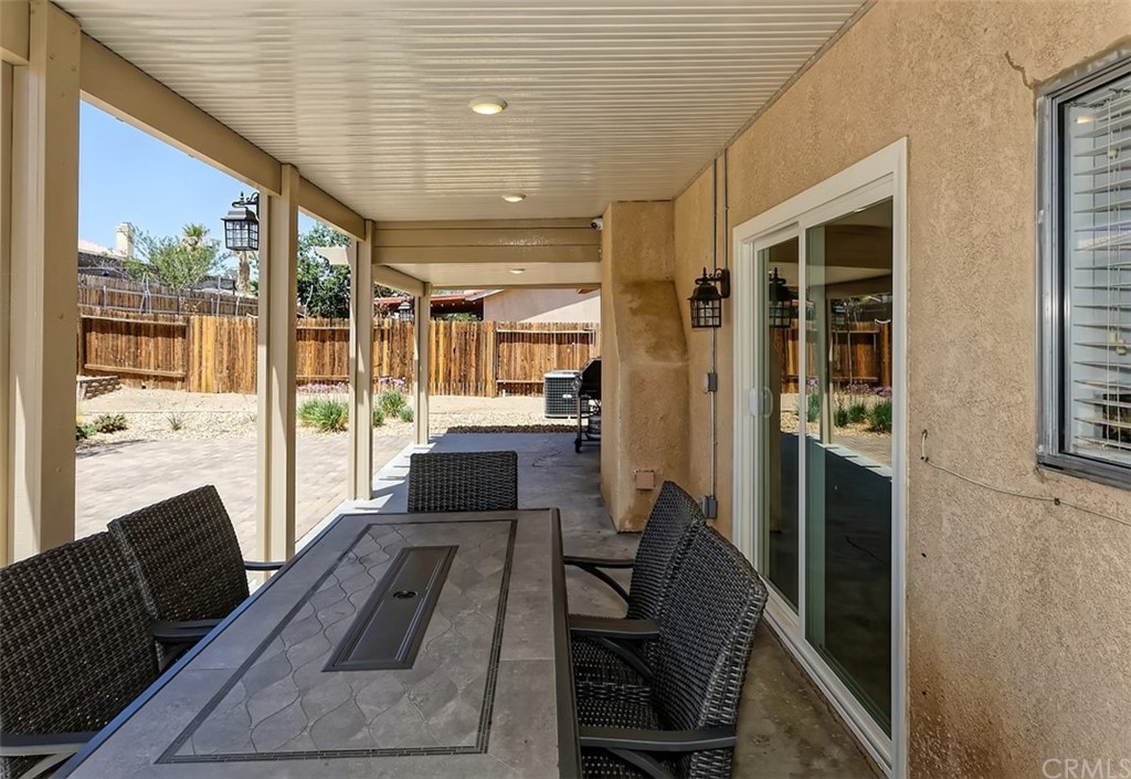 10829 Pepper Street Adelanto, CA 92301 - Photo 42 of 48 a living room with furniture fireplace and flat screen tv
