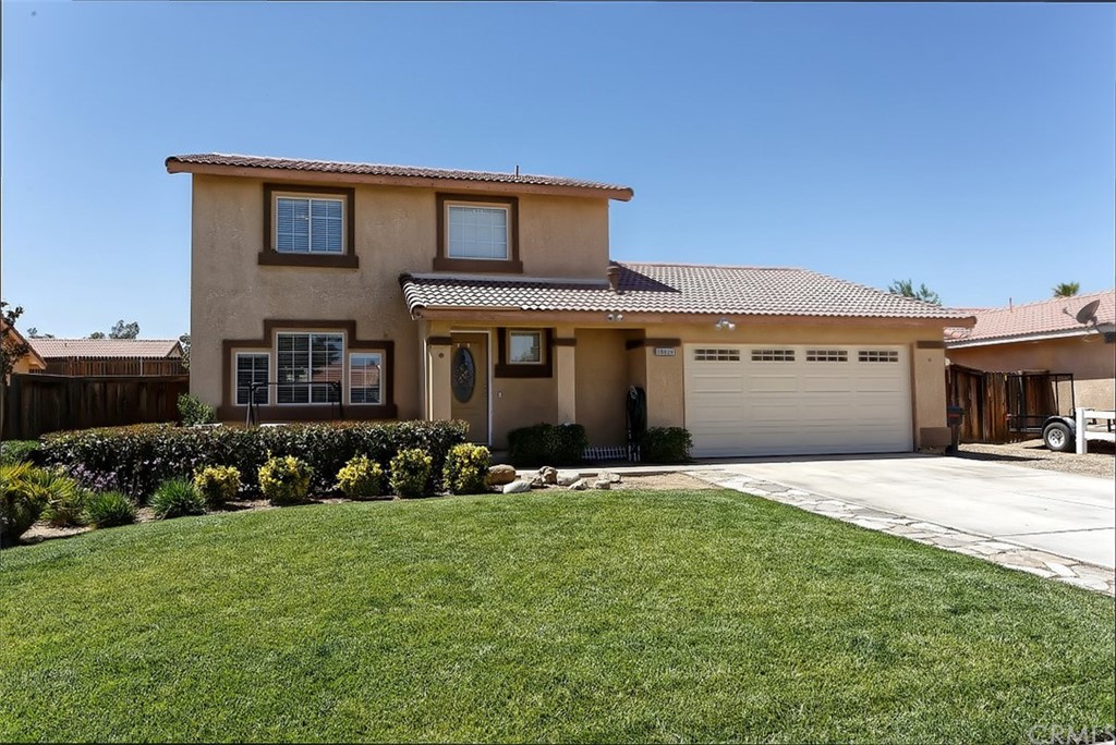 10829 Pepper Street Adelanto, CA 92301 - Photo 5 of 48 a front view of a house with a yard