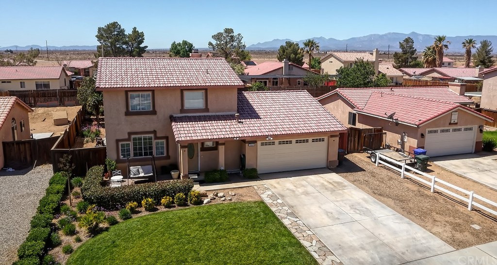10829 Pepper Street Adelanto, CA 92301 - Photo 6 of 48 an aerial view of a house with yard and parking