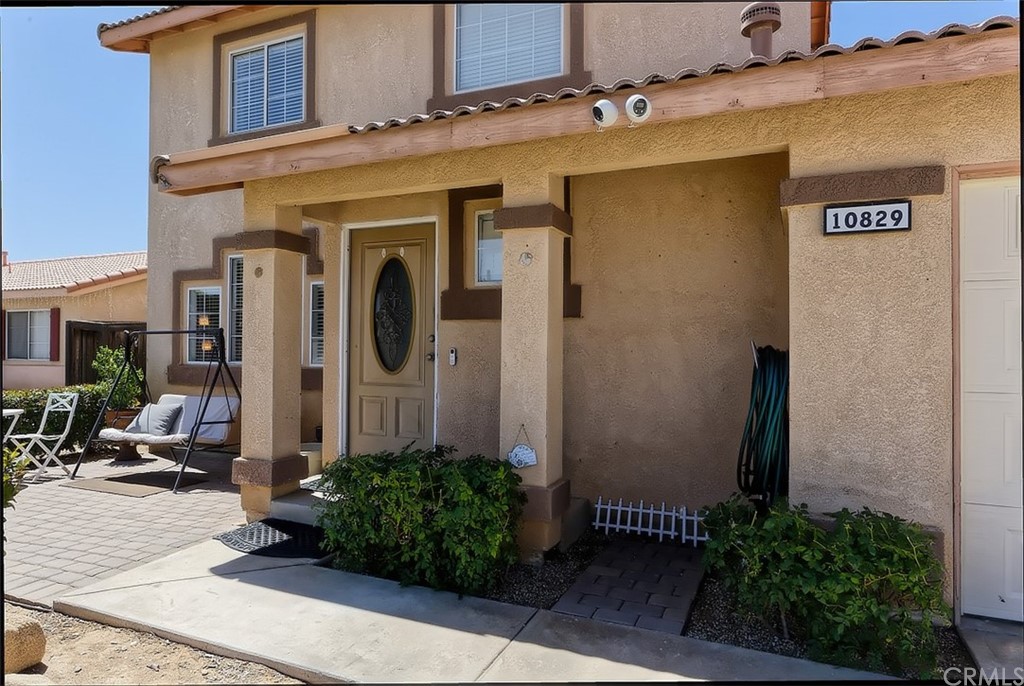 10829 Pepper Street Adelanto, CA 92301 - Photo 9 of 48 a front view of a house with garden