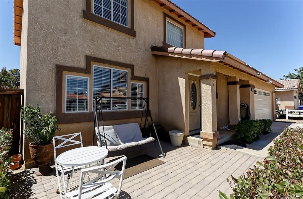10829 Pepper Street Adelanto, CA 92301 - Photo 10 of 48 a view of a patio with couches table and chairs and potted plants