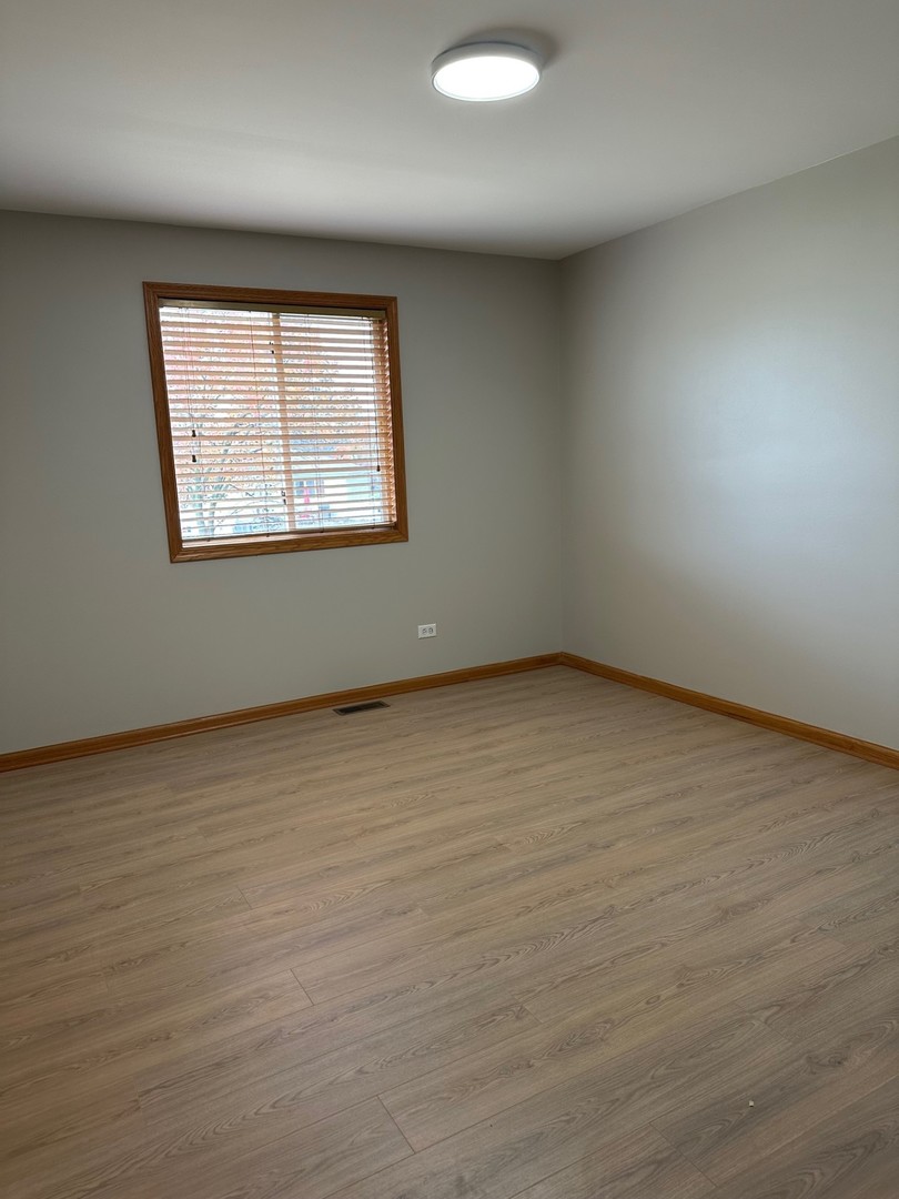 1805 Pebble Beach Drive Plainfield, IL 60586 - Photo 14 of 18 an empty room with wooden floor and windows