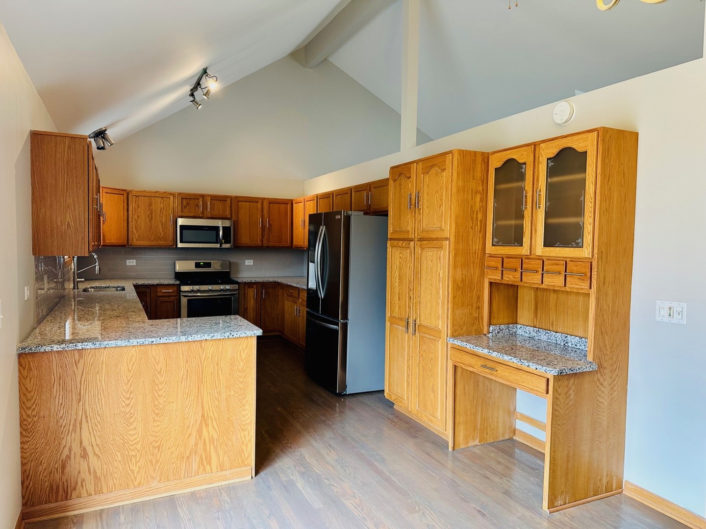 1805 Pebble Beach Drive Plainfield, IL 60586 - Photo 3 of 18 a kitchen with a refrigerator and a stove top oven