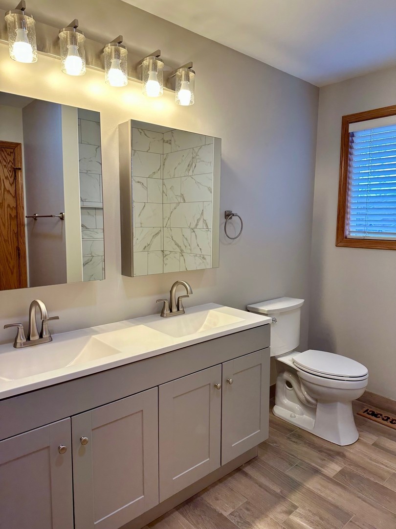 1805 Pebble Beach Drive Plainfield, IL 60586 - Photo 8 of 18 a bathroom with a toilet sink and mirror