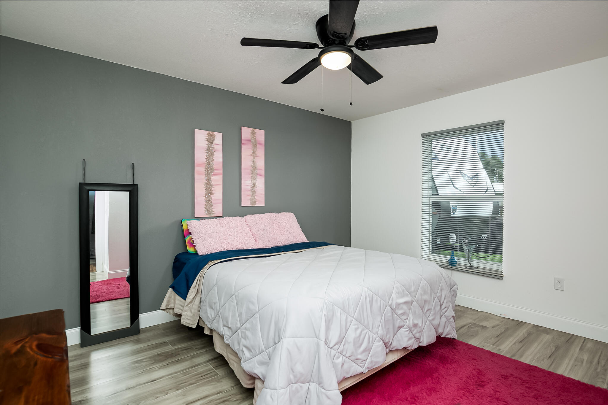 1141 Orange Loop Okeechobee, FL 34974 - Photo 13 of 20 a bedroom with a bed chandelier and a window