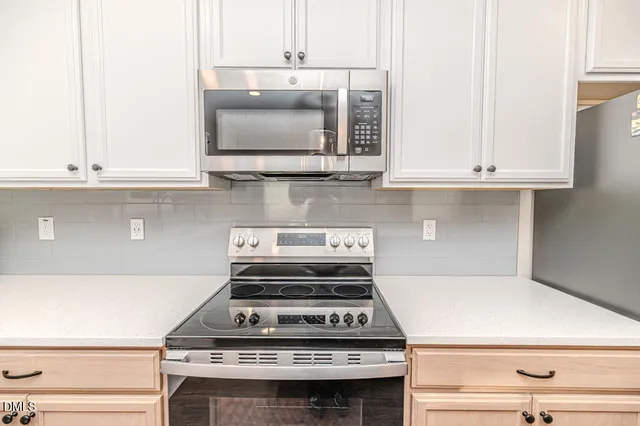 a kitchen with a stove and a microwave