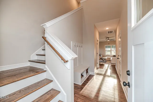 a view of a living room with furniture and stairs