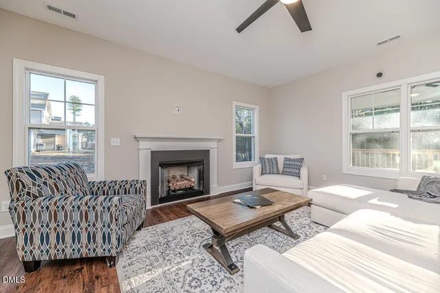 a living room with furniture fireplace and window