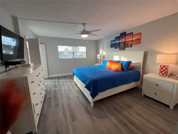 a bedroom with a bed and flat screen tv