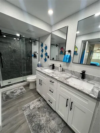 a bathroom with a granite countertop sink mirror and double