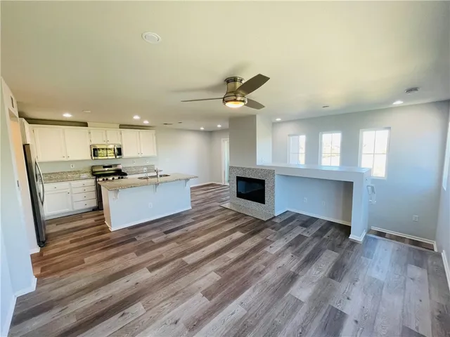 a view of kitchen with sink microwave and stove