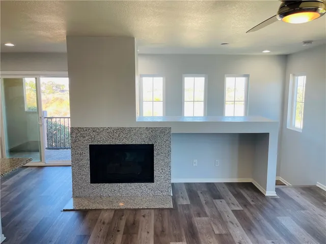 an empty room with wooden floor and fireplace