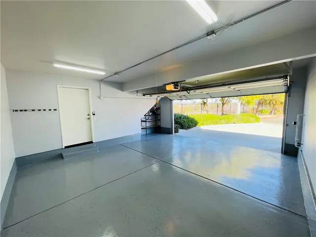 a front view of a house with garden and sitting area