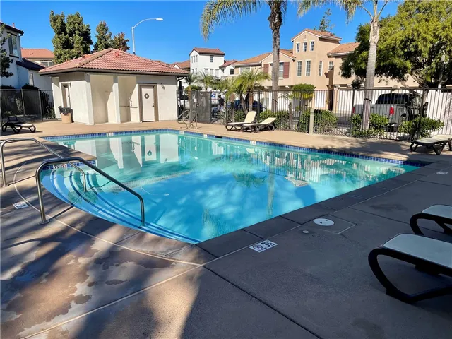 a swimming pool with outdoor seating and yard