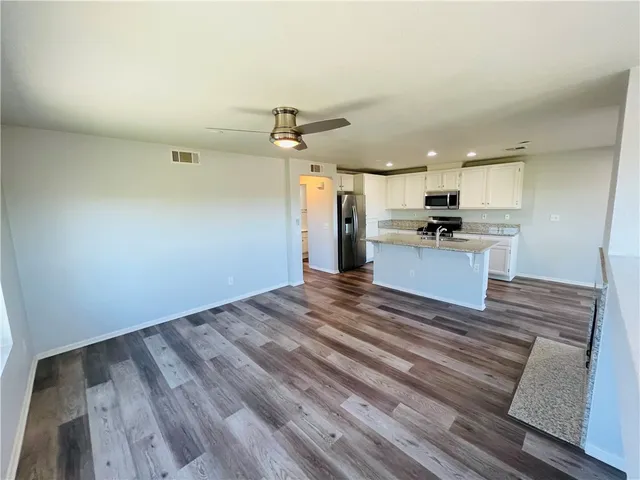 a view of a kitchen with a dishwasher cabinets and wooden floor
