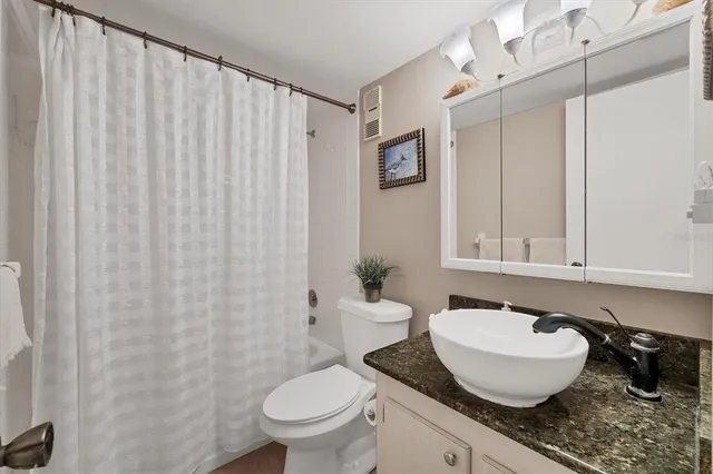 an aerial view of a house with a big yard and large trees