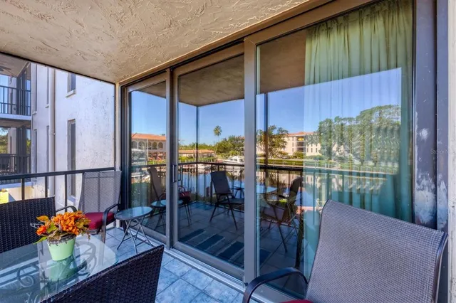 a living room with lots of furniture a chandelier and a dining table