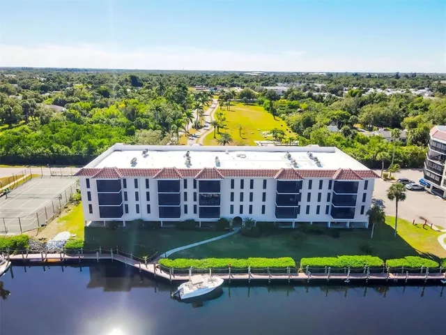 a view of a patio with table and chairs and potted plants