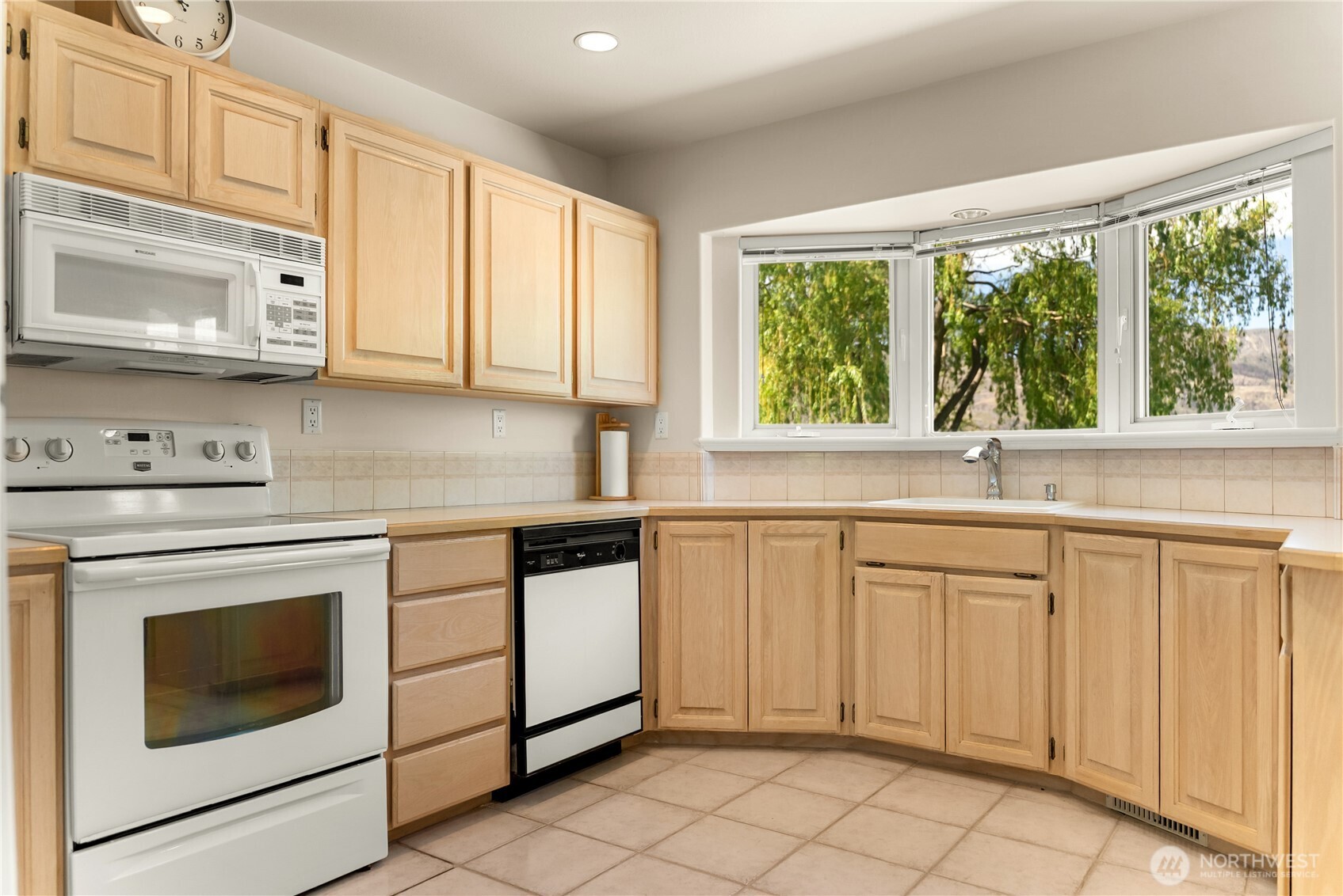 428 Eastlake Road Oroville, WA 98844 - Photo 11 of 34 a kitchen with white cabinets and white appliances